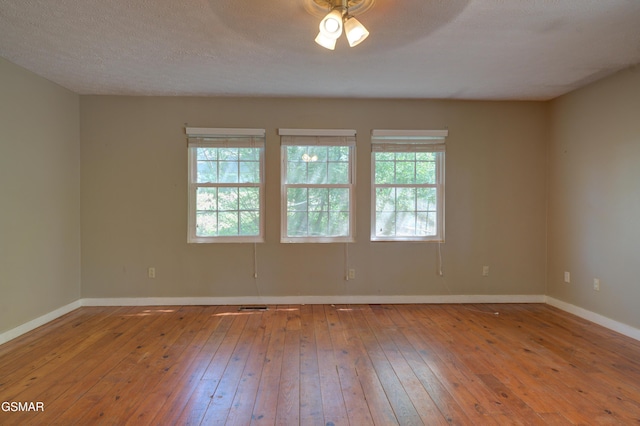 1940 Big Chiefs Skyview Dr, Sevierville, TN 37876 - empty room with wood-type flooring, baseboards, a ceiling fan, and a healthy amount of sunlight