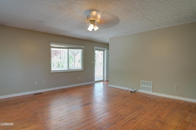 1940 Big Chiefs Skyview Dr, Sevierville, TN 37876 - spare room with a textured ceiling, baseboards, a ceiling fan, and visible vents