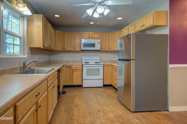 1940 Big Chiefs Skyview Dr, Sevierville, TN 37876 - kitchen featuring a sink, light wood-style flooring, white appliances, and light brown cabinets