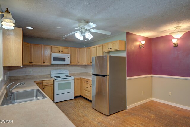 1940 Big Chiefs Skyview Dr, Sevierville, TN 37876 - kitchen featuring light brown cabinets, a sink, white appliances, and light wood-style floors