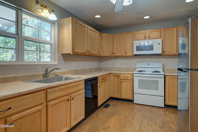 1940 Big Chiefs Skyview Dr, Sevierville, TN 37876 - kitchen featuring a sink, light wood-type flooring, white appliances, and light brown cabinets