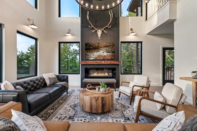 interior space with a healthy amount of sunlight, a fireplace, and a high ceiling