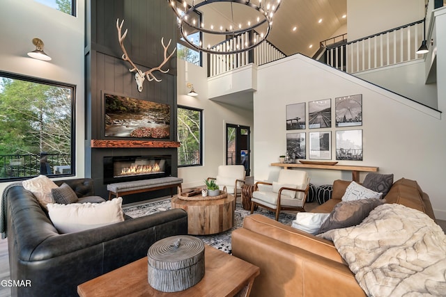 living room with a chandelier, recessed lighting, a fireplace, and high vaulted ceiling