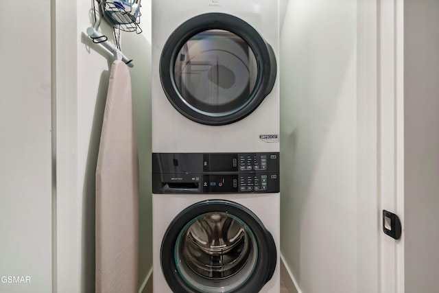 laundry room with stacked washer and dryer and laundry area