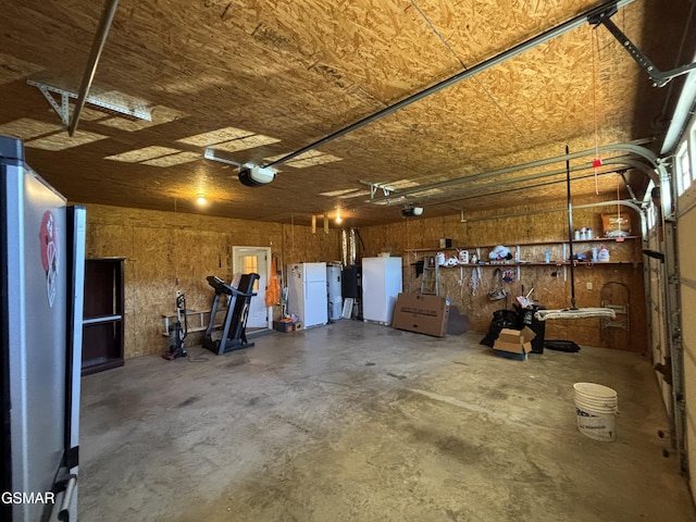 147 Padgett Mill Rd, Cosby, TN 37722 - garage with freestanding refrigerator and a garage door opener
