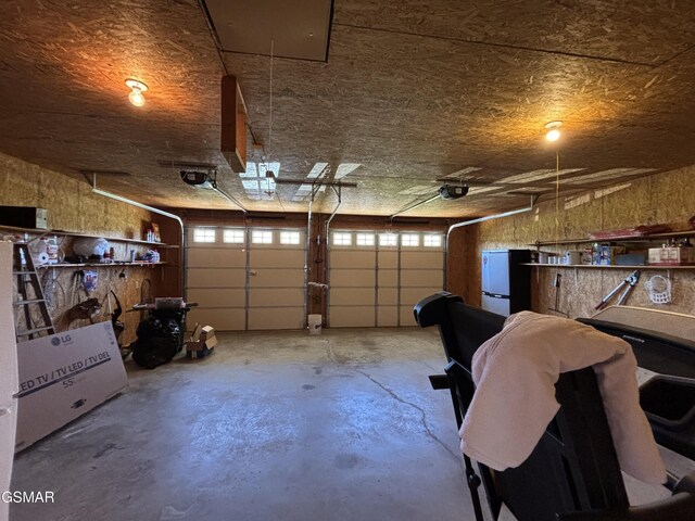 147 Padgett Mill Rd, Cosby, TN 37722 - garage with a garage door opener and refrigerator