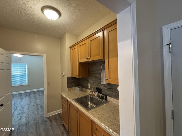147 Padgett Mill Rd, Cosby, TN 37722 - kitchen featuring dark wood-style floors, light countertops, a sink, decorative backsplash, and a textured ceiling