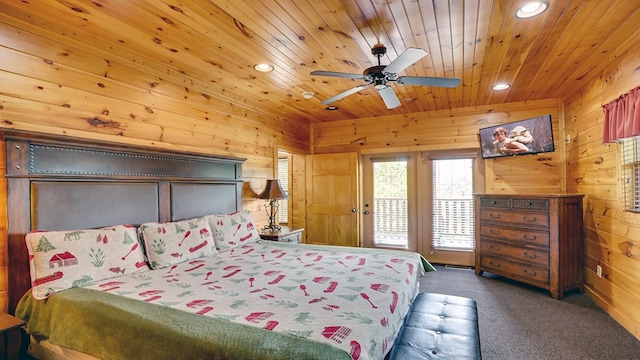 carpeted bedroom with wood ceiling, ceiling fan, and wood walls