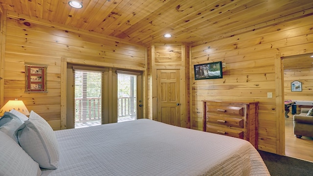 carpeted bedroom with access to outside, wood walls, and wood ceiling