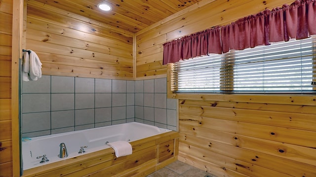 bathroom with tile patterned floors and a bathing tub