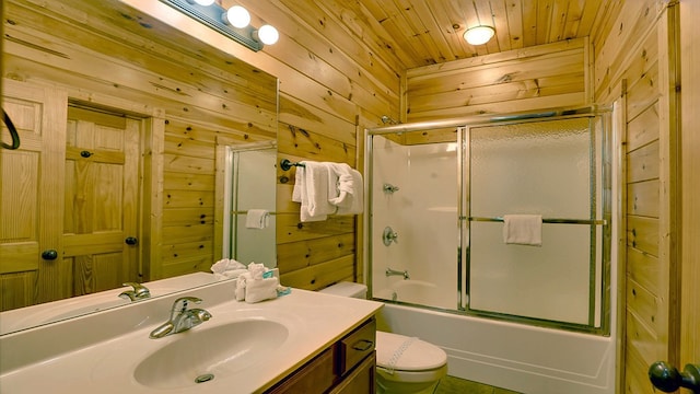 full bathroom with vanity, wood walls, bath / shower combo with glass door, toilet, and wood ceiling