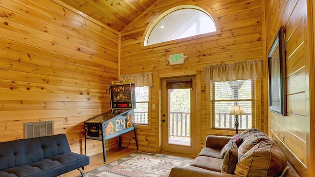 living room featuring wooden walls, high vaulted ceiling, wood ceiling, and hardwood / wood-style flooring