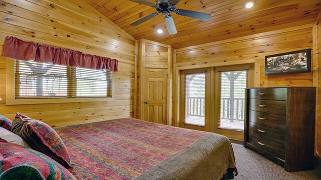 bedroom featuring ceiling fan, wooden walls, carpet floors, and lofted ceiling