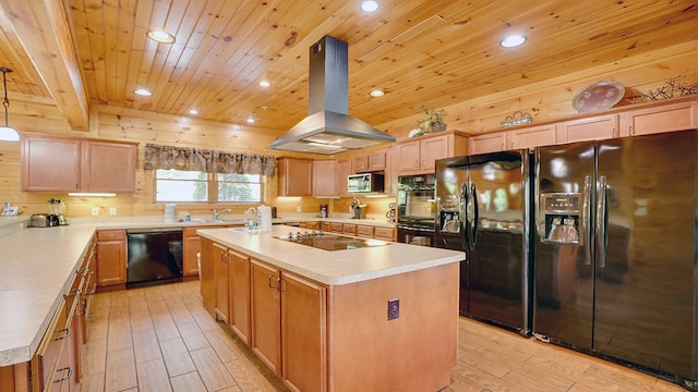 kitchen featuring a center island with sink, decorative light fixtures, island exhaust hood, and black appliances