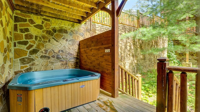 wooden terrace featuring a hot tub