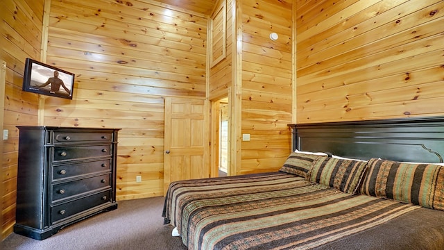 carpeted bedroom with wooden walls