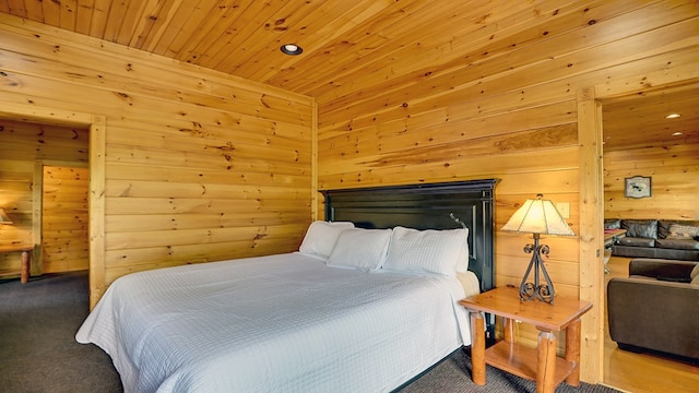 carpeted bedroom featuring wood walls and wooden ceiling