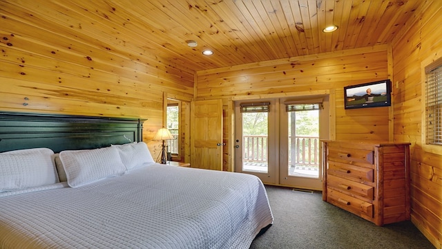 carpeted bedroom with access to exterior, wood walls, and wooden ceiling