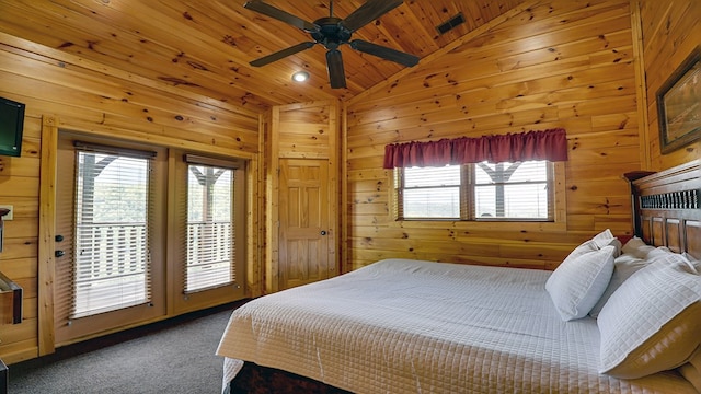 bedroom featuring carpet, wood walls, lofted ceiling, ceiling fan, and wood ceiling