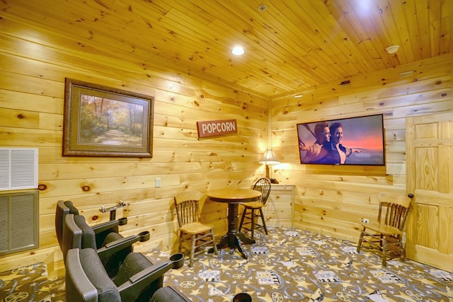 living area with carpet flooring, wood walls, and wood ceiling