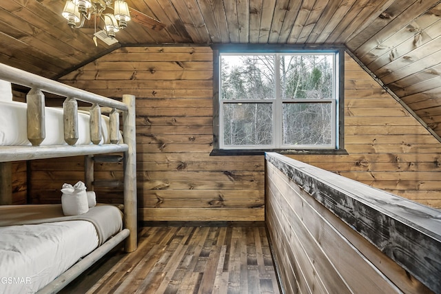 unfurnished bedroom with wooden ceiling, wood-type flooring, vaulted ceiling, and wood walls