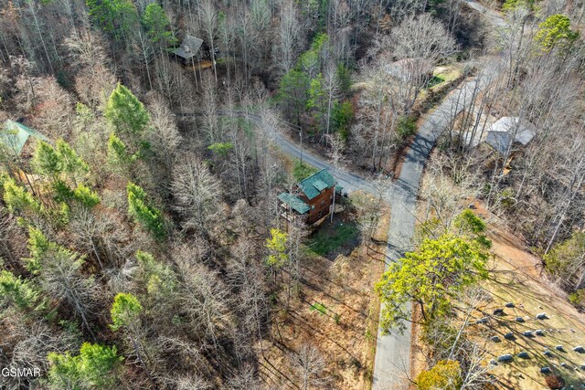 birds eye view of property featuring a wooded view