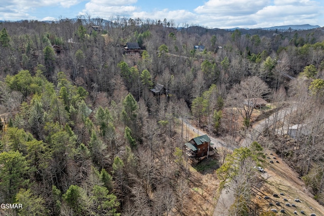 birds eye view of property featuring a view of trees