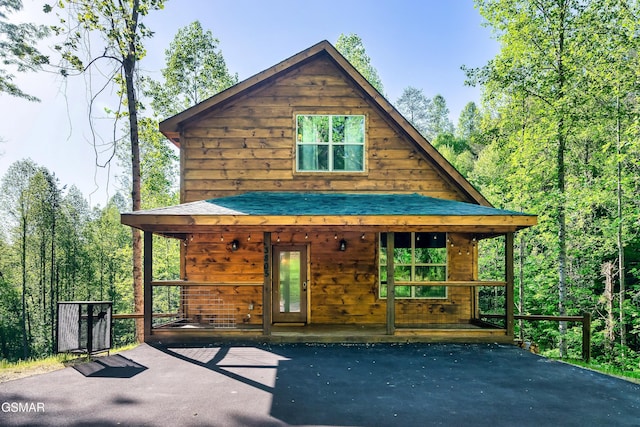 rear view of house with covered porch