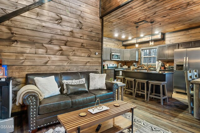 living room with wooden ceiling, dark wood finished floors, and wooden walls