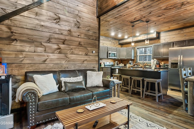 living area featuring dark wood finished floors, wood ceiling, and wood walls