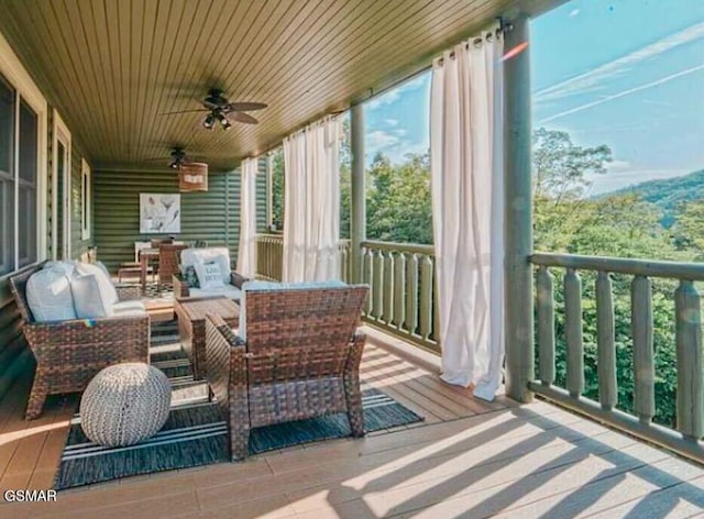 sunroom / solarium featuring ceiling fan and wooden ceiling