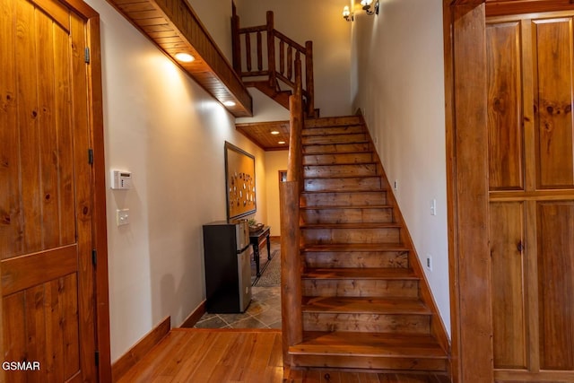 staircase with hardwood / wood-style floors