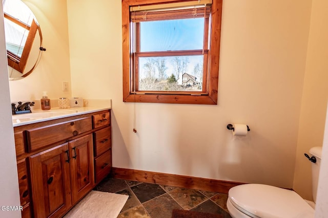 bathroom featuring vanity and toilet