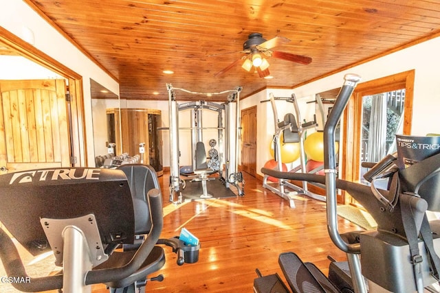 workout area with crown molding, light wood-type flooring, ceiling fan, and wood ceiling