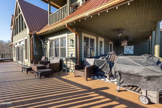 wooden deck with ceiling fan and an outdoor hangout area