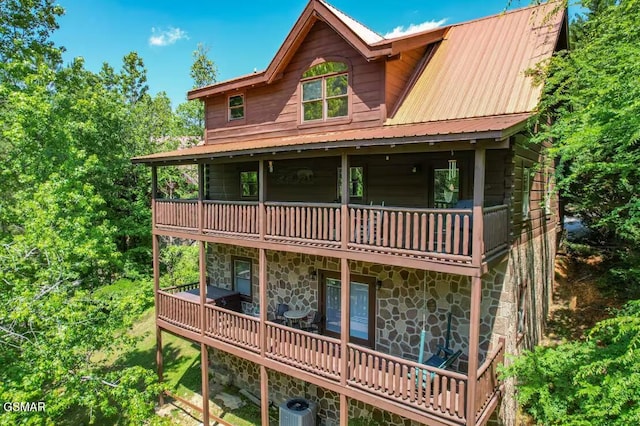 2430 Cobbler Way, Pigeon Forge, TN 37863 - view of front facade featuring stone siding, a balcony, and a metal roof