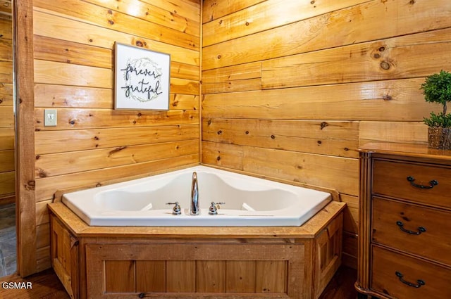 2430 Cobbler Way, Pigeon Forge, TN 37863 - bathroom with a garden tub, wooden walls, and wood finished floors