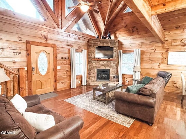 2430 Cobbler Way, Pigeon Forge, TN 37863 - living area featuring wooden walls, ceiling fan, wood ceiling, hardwood / wood-style flooring, and a stone fireplace