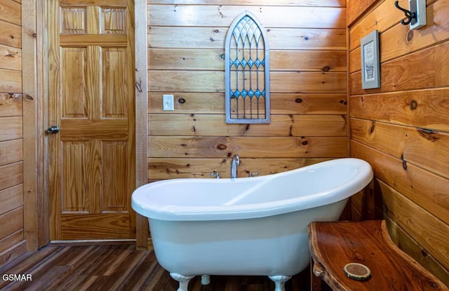 2430 Cobbler Way, Pigeon Forge, TN 37863 - bathroom featuring a freestanding bath, wood finished floors, and wood walls