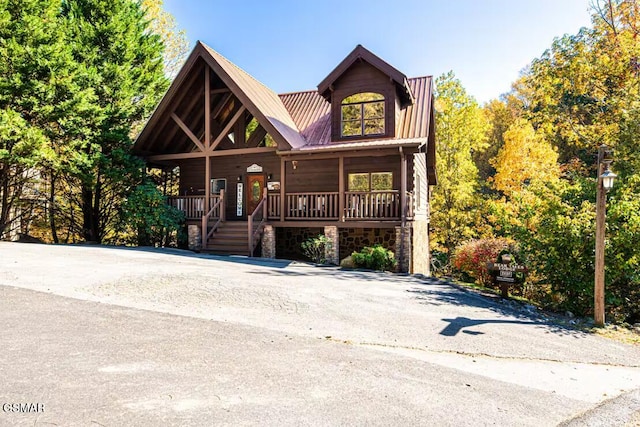 2430 Cobbler Way, Pigeon Forge, TN 37863 - view of front of house featuring a porch, stone siding, and a metal roof