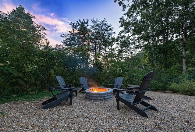 yard at dusk featuring a fire pit