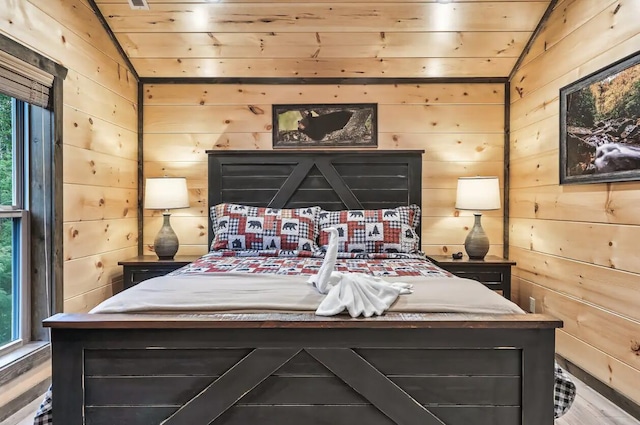 bedroom with vaulted ceiling, wooden ceiling, and wood walls