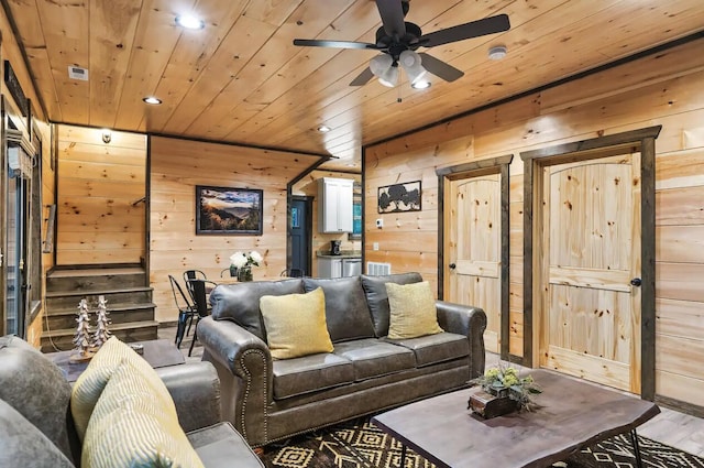 living room featuring hardwood / wood-style floors, ceiling fan, wood walls, and wood ceiling