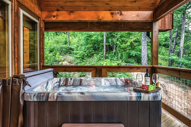 wooden deck featuring a hot tub