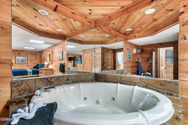 bathroom with wooden walls, a bathtub, and wooden ceiling