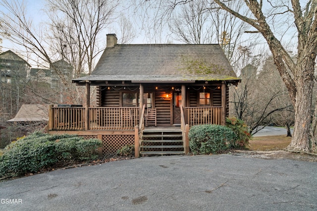 log cabin with a porch