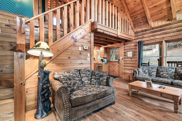 living room with log walls, hardwood / wood-style flooring, high vaulted ceiling, wooden ceiling, and beamed ceiling