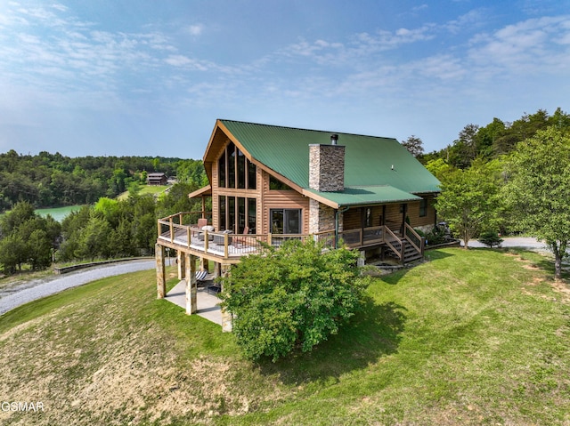 3829 Island View Rd, Sevierville, TN 37876 - rear view of property featuring driveway, a yard, metal roof, and a deck