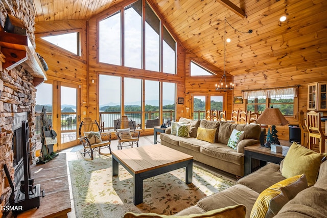 3829 Island View Rd, Sevierville, TN 37876 - living area with high vaulted ceiling, wood walls, a chandelier, wood finished floors, and a fireplace