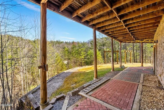 view of patio featuring a forest view